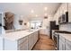 Spacious kitchen offering a large center island, stainless steel appliances, ample cabinet space and hardwood floors at 8194 Bostic Ct, Fishers, IN 46038