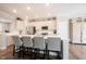 Open kitchen with white cabinets, stainless steel appliances, a center island with seating and hardwood flooring at 8194 Bostic Ct, Fishers, IN 46038