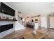 View of living room fireplace and kitchen, and staircase with wood floors at 8194 Bostic Ct, Fishers, IN 46038