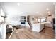 Open-concept living room and kitchen area with hardwood floors and modern fireplace at 8194 Bostic Ct, Fishers, IN 46038