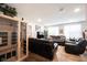 Bright and airy living room showcasing a modern sauna, hardwood floors, and comfortable leather seating at 8194 Bostic Ct, Fishers, IN 46038