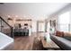 Open concept living space with kitchen, stairs, and inviting gray sofa and wood accents at 8194 Bostic Ct, Fishers, IN 46038