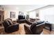 Comfortable living room with leather seating, entertainment center, and bright natural light at 8194 Bostic Ct, Fishers, IN 46038