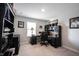 Bright home office with black furniture, a desk, and ample storage at 8194 Bostic Ct, Fishers, IN 46038