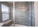 Modern tiled shower with a built-in bench and window at 8194 Bostic Ct, Fishers, IN 46038