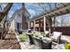 Large outdoor patio with comfortable seating, a pergola, lush landscaping, a home exterior, and a serene atmosphere at 827 N Park Ave, Indianapolis, IN 46202