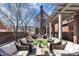 Large outdoor patio with comfortable seating, a pergola, lush landscaping, a home exterior, and a relaxing atmosphere at 827 N Park Ave, Indianapolis, IN 46202