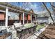 Large outdoor patio with comfortable seating, a pergola, lush landscaping, a home exterior, and serene atmosphere at 827 N Park Ave, Indianapolis, IN 46202