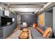 Finished basement with gray walls, built-in shelving, a large TV, comfortable seating, and hardwood floors at 827 N Park Ave, Indianapolis, IN 46202