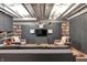 Finished basement with gray walls, built-in shelving, a large TV, and comfortable seating area at 827 N Park Ave, Indianapolis, IN 46202