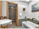 Bright bathroom featuring a shower, bath, tiled floors, custom cabinetry, and stylish fixtures at 827 N Park Ave, Indianapolis, IN 46202