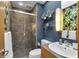 Modern bathroom with shower, stylish vanity, large mirror and unique wallpaper at 827 N Park Ave, Indianapolis, IN 46202