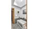 Bright bathroom featuring a bath, tiled floors, skylight, and stylish fixtures at 827 N Park Ave, Indianapolis, IN 46202