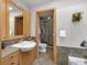 Bright bathroom featuring a shower, bath, tiled floors, custom cabinetry, and stylish fixtures at 827 N Park Ave, Indianapolis, IN 46202