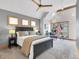 Main bedroom with a ceiling fan, a large bed, and windows overlooking the exterior landscape at 827 N Park Ave, Indianapolis, IN 46202
