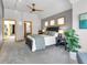Bedroom features a dark bed frame, neutral bedding, and gray walls with wood-trimmed windows at 827 N Park Ave, Indianapolis, IN 46202