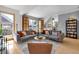 Spacious living room with two gray sofas, a round coffee table, and a view of the staircase at 827 N Park Ave, Indianapolis, IN 46202