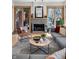 Bright living room features a gray sofa, a modern fireplace, and sliding doors to the outside at 827 N Park Ave, Indianapolis, IN 46202
