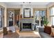 Cozy living room featuring a stone fireplace, comfortable seating, and natural light from sliding doors at 827 N Park Ave, Indianapolis, IN 46202