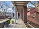 Inviting covered patio with stone pavers, brick pillars, and stylish outdoor seating for relaxing or entertaining at 827 N Park Ave, Indianapolis, IN 46202