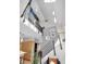 Modern staircase with metal railings and natural light from large windows at 827 N Park Ave, Indianapolis, IN 46202