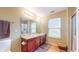 Well-lit bathroom with double sink vanity, large mirror, and tiled floors at 8536 Blue Marlin Dr, Indianapolis, IN 46239