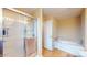 Bright bathroom featuring a glass shower, soaking tub, and neutral tile flooring for a relaxing retreat at 8536 Blue Marlin Dr, Indianapolis, IN 46239