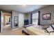 Neutral tone bedroom featuring comfortable bed, artwork, closet, and dark curtains for restful retreat at 8536 Blue Marlin Dr, Indianapolis, IN 46239