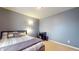 Neutral tone bedroom featuring comfortable bed, floor lamp, and desk for a serene and practical space at 8536 Blue Marlin Dr, Indianapolis, IN 46239