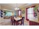 Elegant dining room featuring a chandelier, large windows, and stylish decor, ideal for Gathering gatherings at 8536 Blue Marlin Dr, Indianapolis, IN 46239