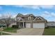 Two-story home features a brick and brown siding exterior, attached two-car garage, and manicured front lawn at 8536 Blue Marlin Dr, Indianapolis, IN 46239