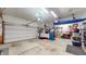 Spacious two-car garage with ample storage space, tools, and overhead storage at 8536 Blue Marlin Dr, Indianapolis, IN 46239