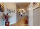 Inviting hallway with tiled floors, decorative wall art, and stairs leading to the upper level at 8536 Blue Marlin Dr, Indianapolis, IN 46239