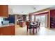 Bright kitchen with island, tile floors, wood cabinets and sliding glass doors to the backyard at 8536 Blue Marlin Dr, Indianapolis, IN 46239