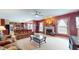 Cozy living room with fireplace, large windows, comfortable seating and view of kitchen at 8536 Blue Marlin Dr, Indianapolis, IN 46239