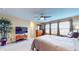 Spacious main bedroom with ceiling fan, large windows, and a seating area at 8536 Blue Marlin Dr, Indianapolis, IN 46239