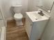 Bathroom with toilet and vanity on newer wood-look flooring at 937 N Bosart Ave, Indianapolis, IN 46201