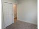 Cozy bedroom with neutral carpet and a white door leads to another room at 937 N Bosart Ave, Indianapolis, IN 46201