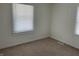 Bedroom featuring a bright window with blinds and neutral carpeting at 937 N Bosart Ave, Indianapolis, IN 46201