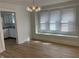 Well-lit dining area with wood floors, large windows with a bench, and an archway leading into the kitchen at 937 N Bosart Ave, Indianapolis, IN 46201