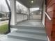 Covered front porch with painted floor and steps. Includes updated railing and views of the friendly neighborhood at 937 N Bosart Ave, Indianapolis, IN 46201