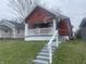 Charming craftsman home with a cozy front porch and freshly painted steps in a residential neighborhood at 937 N Bosart Ave, Indianapolis, IN 46201