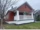 Craftsman home showcasing freshly updated landscaping, featuring a cozy porch and an American flag at 937 N Bosart Ave, Indianapolis, IN 46201