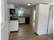 Efficient kitchen featuring white cabinets, granite countertops, modern appliances, and wood floors at 937 N Bosart Ave, Indianapolis, IN 46201