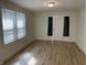 Bright living room featuring wood floors, a large window, and neutral paint, creating a cozy and inviting space at 937 N Bosart Ave, Indianapolis, IN 46201