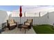 A fenced backyard features outdoor seating, a small side table, and faux turf at 9694 Angelica Dr, Noblesville, IN 46060
