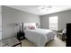 Neutral bedroom with white bedding, bedside tables with lamps, and a window at 9694 Angelica Dr, Noblesville, IN 46060