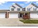 Inviting townhome featuring a two-car garage, charming curb appeal, and a classic facade with stylish accents at 9694 Angelica Dr, Noblesville, IN 46060