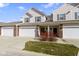 Inviting townhome featuring a two-car garage, charming curb appeal, and a classic facade with stylish accents at 9694 Angelica Dr, Noblesville, IN 46060