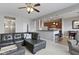 Comfortable living area seamlessly connecting to the kitchen, featuring a spacious sectional sofa, and modern lighting at 9694 Angelica Dr, Noblesville, IN 46060